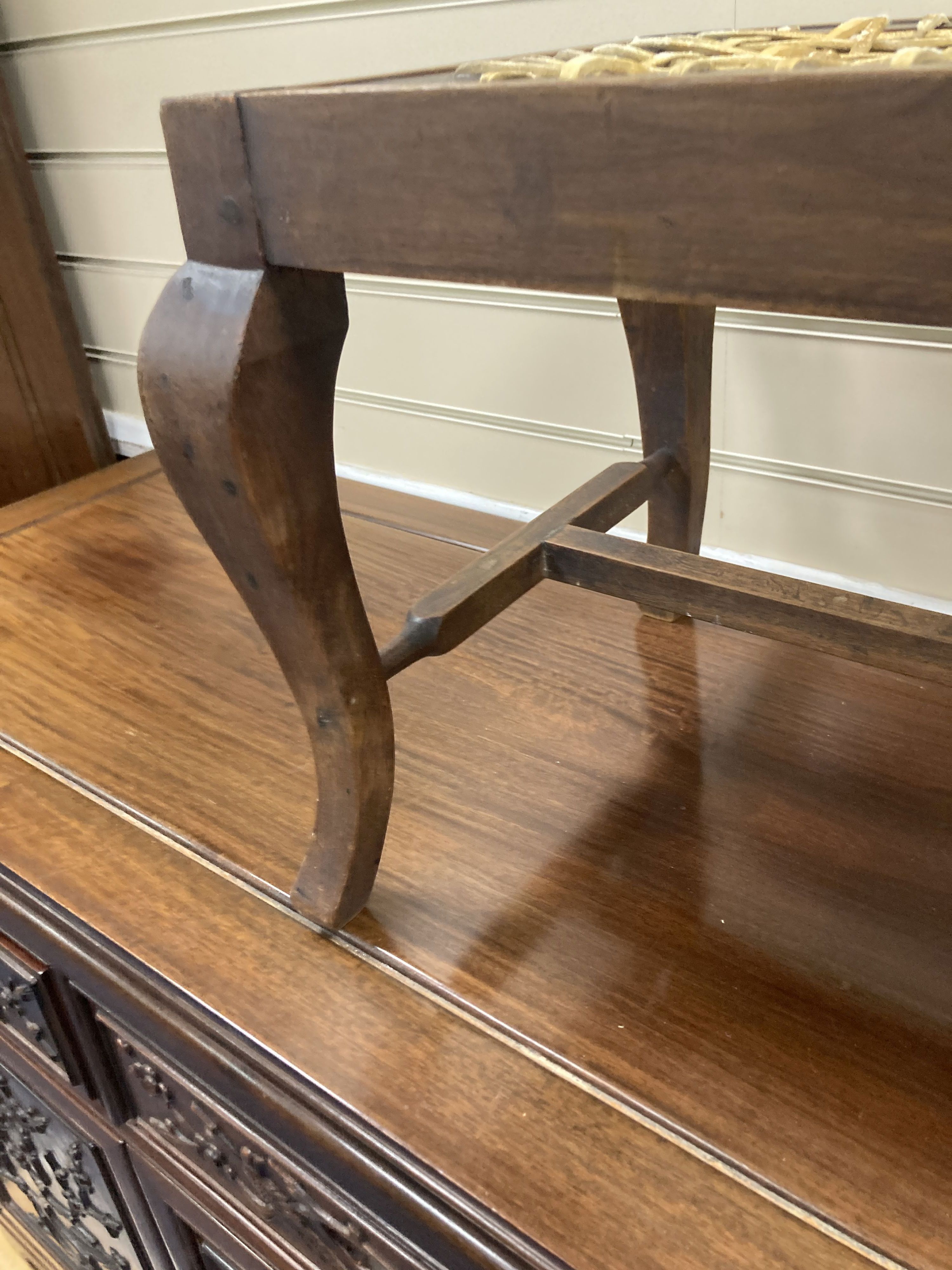 An early 20th century mahogany framed luggage stool with woven strapwork top, 35cm high, width 76cm, depth 34cm